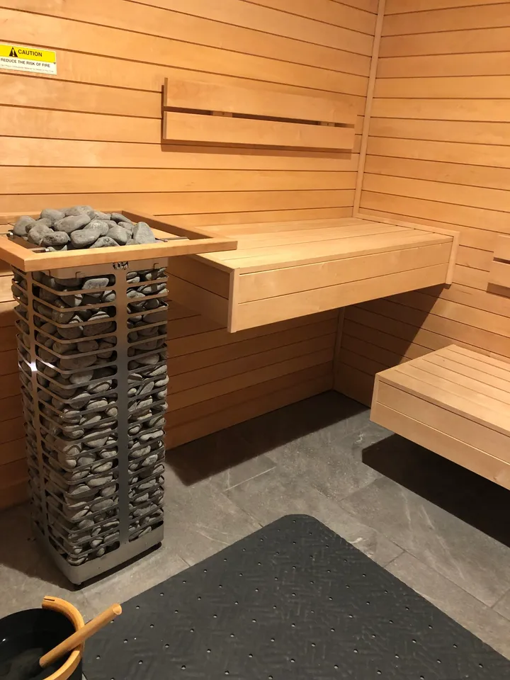 Wooden sauna interior with stone heater